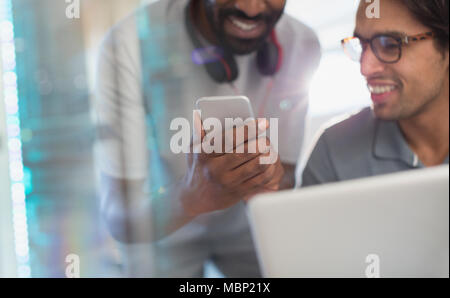 Smiling creative businessmen using smart phone Stock Photo