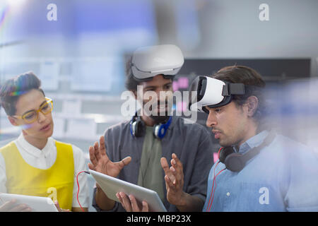 Computer programmers with digital tablet programming virtual reality simulators Stock Photo