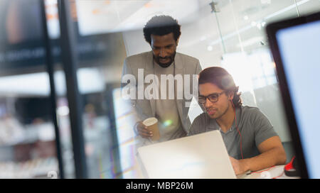 Creative businessmen working at laptop in office Stock Photo