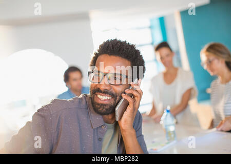 Smiling, confident businessman talking on smart phone Stock Photo