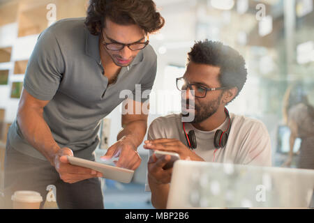 Creative businessmen using digital tablet and smart phone in office Stock Photo