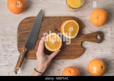 cropped image of woman preparing homemade orange juice Stock Photo