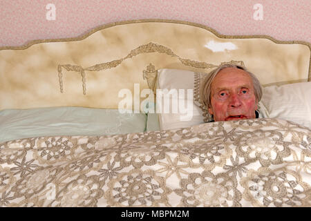 Old age pensioner awake in bed Stock Photo
