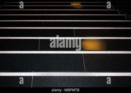Abstract background of black granite staircase with white horizontal stripes. Stock Photo