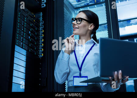 Cheerful operator working in a server cabinet Stock Photo