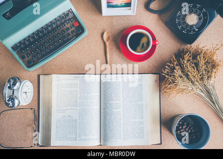 A cup of coffee with typewriter , alarm clock , telephone , notebook . top view image Stock Photo