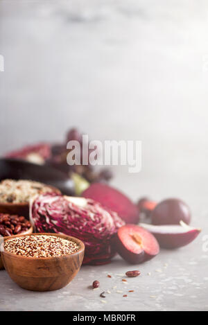 Concept of fruits with plums on gray textured table Stock Photo - Alamy