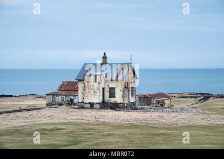 Near Garður on the Reyjanes peninsula, Iceland. Old corrugated iron buildings at an abandoned farm on the coast. Stock Photo