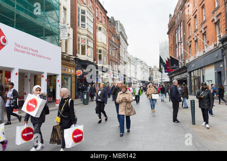 DUBLIN, IRELAND - 07 MAY, 2016: People walking on the Grafton Street. The main shopping street in the city is one of the most expensive in the world. Stock Photo