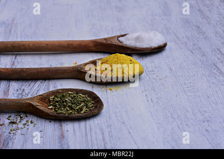 Colorful spices in spoons on white wooden background, Top view/Kitchen- Food background Stock Photo