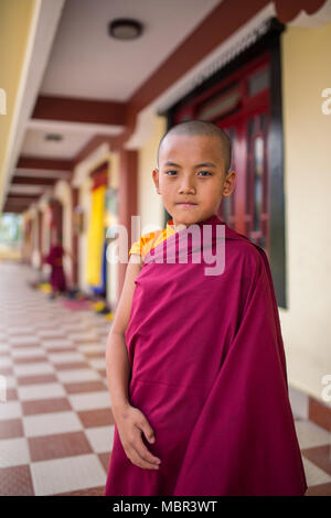 Gangtok, India - May 3, 2017: Unidentified young novice buddhist monk in traditional red robes standing in front of Tsuglakhang monastery in Gangtok,  Stock Photo