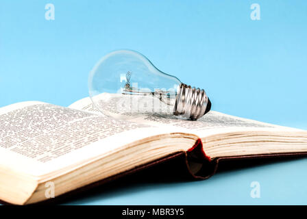 Bulb on an open old book close-up Stock Photo