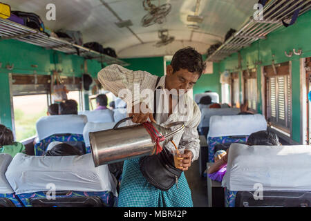 Yangon, Myanmar - October 15, 2016: Unidentified burmese man selling tea in the train in Myanmar. Stock Photo