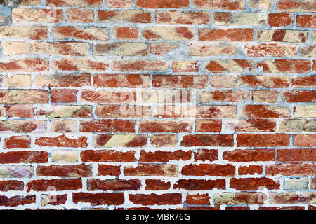 Background of weathered red brick wall and grey white mortar, vibrant colors Stock Photo