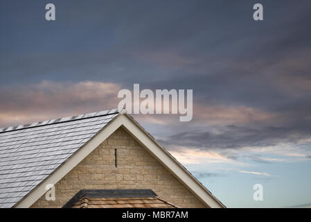 An image of stone, slate and tiles on the facade of a modern building in England, UK. Stock Photo