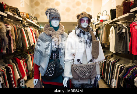 Womens knitted winter clothes on mannequins in shop Stock Photo