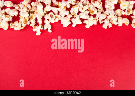 Popcorn on red background with free space, top view Stock Photo