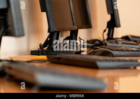 Group of computer neatly placed in a computer lab shallow dof image from table level Stock Photo