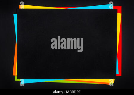 Colorful paper sheets stack on black background. Stock Photo