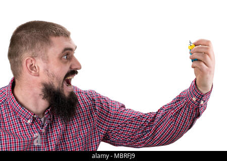 Morning wake up concept. Guy with furious face holds alarm clock. Isolated on white background. Stock Photo