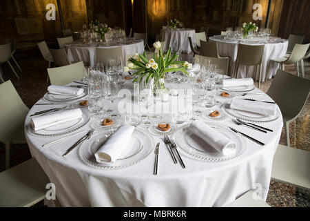 wedding table setting with atulips vases and seating for guests with bread stick heart shape. Stock Photo