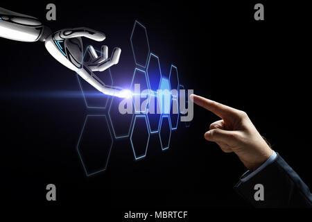 robot and human hand touching network hologram Stock Photo