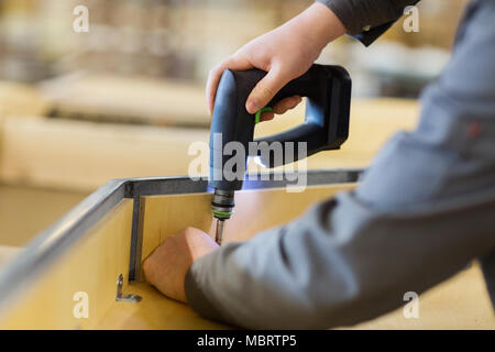 assembler with screwdriver making furniture Stock Photo