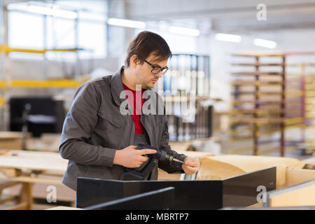 assembler with screwdriver making furniture Stock Photo