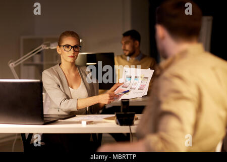 workers with user interface mockup at night office Stock Photo