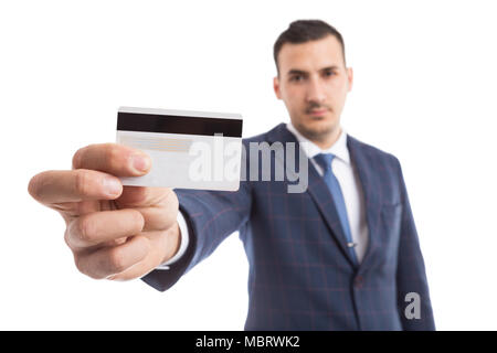Young handsome businessman or salesman holding empty white credit card as secure online payment concept isolated on white background Stock Photo