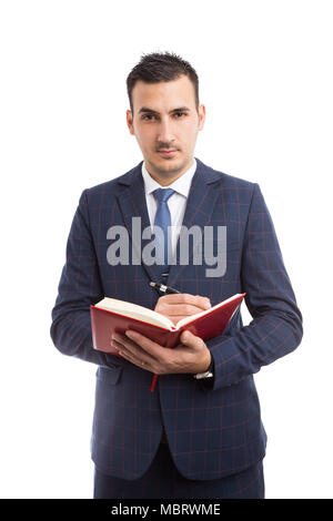 Young handsome salesman holding and writing in agenda as teacher concept isolated on white background Stock Photo