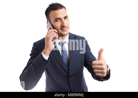 Young handsome businessman using smartphone smiling and making OK gesture as successful work concept isoalted on white background Stock Photo