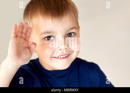 portrait of happy smiling little boy waving hand Stock Photo