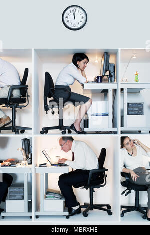Office workers in tiny cubicles Stock Photo