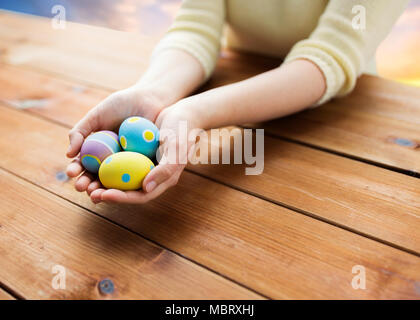 close up of woman hands with colored easter eggs Stock Photo