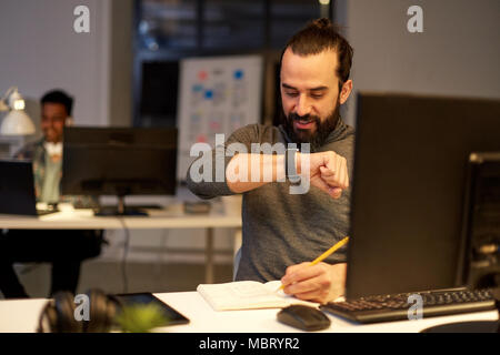 man with smartwatch using voice recorder at office Stock Photo