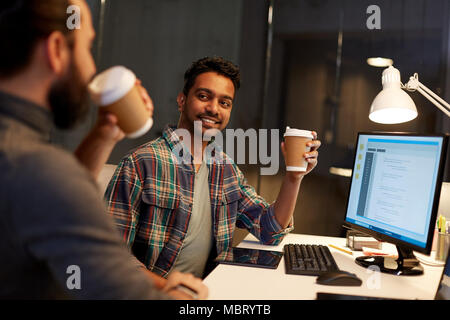 creative team drinking coffee at night office Stock Photo