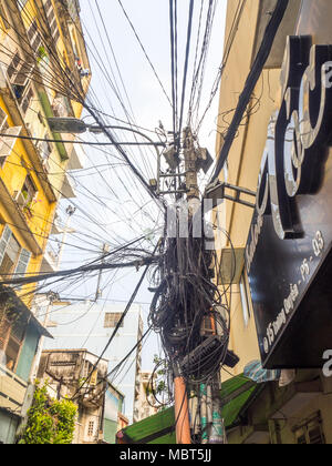 Electrical and telephone wires tangled  up on power poles in Ho Chi Minh City, Vietnam. Stock Photo