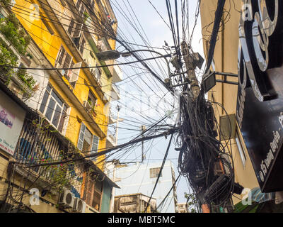 Electrical and telephone wires tangled  up on power poles in Ho Chi Minh City, Vietnam. Stock Photo