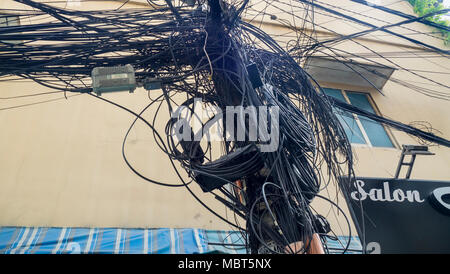 Electrical and telephone wires tangled  up on power poles in Ho Chi Minh City, Vietnam. Stock Photo