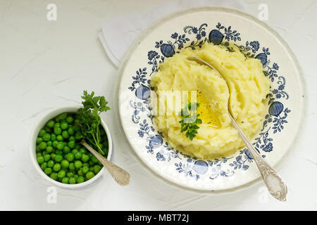 Appetizing mashed potatoes with butter and parsley. Rustic style. Stock Photo
