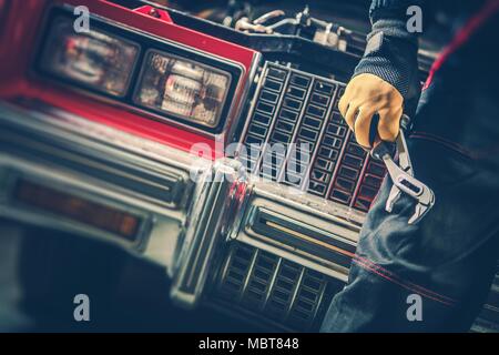 Classic Car Repair Restoration. Vehicle Mechanic with Tools in Front of Vintage Car. Stock Photo