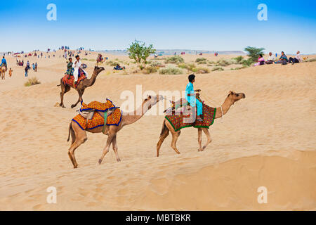 JAISALMER, INDIA - OCTOBER 13: Unidenfified people and camels in Thar desert on October 13, 2013, Jaisalmer, India. Stock Photo
