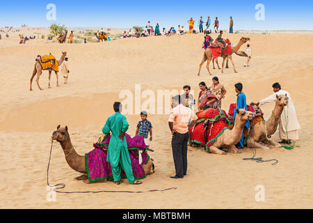 JAISALMER, INDIA - OCTOBER 13: Unidenfified people and camels in Thar desert on October 13, 2013, Jaisalmer, India. Stock Photo