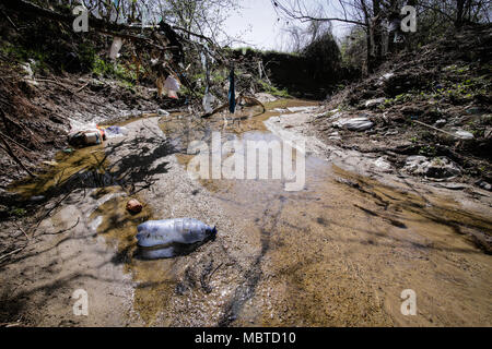 Heavy polluted water stream with domestic garbage Stock Photo - Alamy