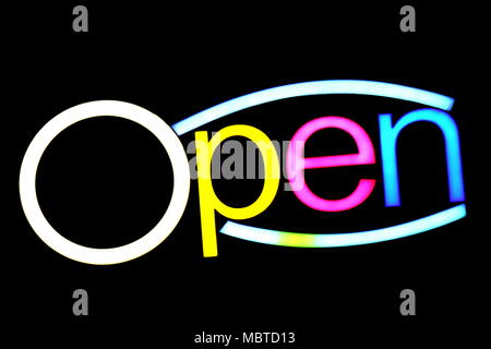 blurred text OPEN sign LED Bokeh light colorful on dark wall, Neon Light led letter Open on background black Stock Photo