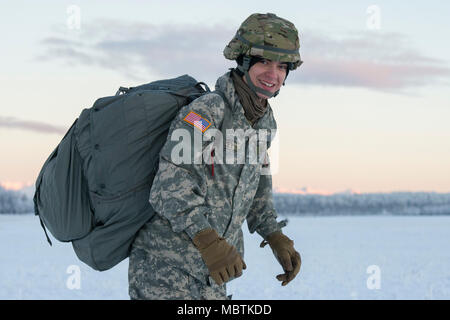 Army Pvt. Conner Langley, a native of Baton Rouge, La., assigned to the 6th Brigade Engineer Battalion, 4th Infantry Brigade Combat Team (Airborne), 25th Infantry Division, U.S. Army Alaska, smiles after completing his first airborne training jump at Malemute drop zone, Joint Base Elmendorf-Richardson, Alaska, Jan. 9, 2018. The Soldiers of 4/25 belong to the only American airborne brigade in the Pacific and are trained to execute airborne maneuvers in extreme cold weather/high altitude environments in support of combat, training and disaster relief operations. (U.S. Air Force photo by Alejandr Stock Photo