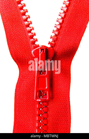 Red zipper with a runner on a white background. Close-up. Stock Photo