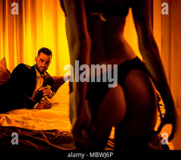 clothes off sexy Sensual woman taking off her clothes in front of a lover Stock Photo