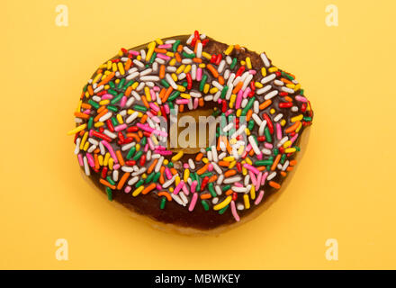 Sprinkle Donuts on a Yellow Background Stock Photo